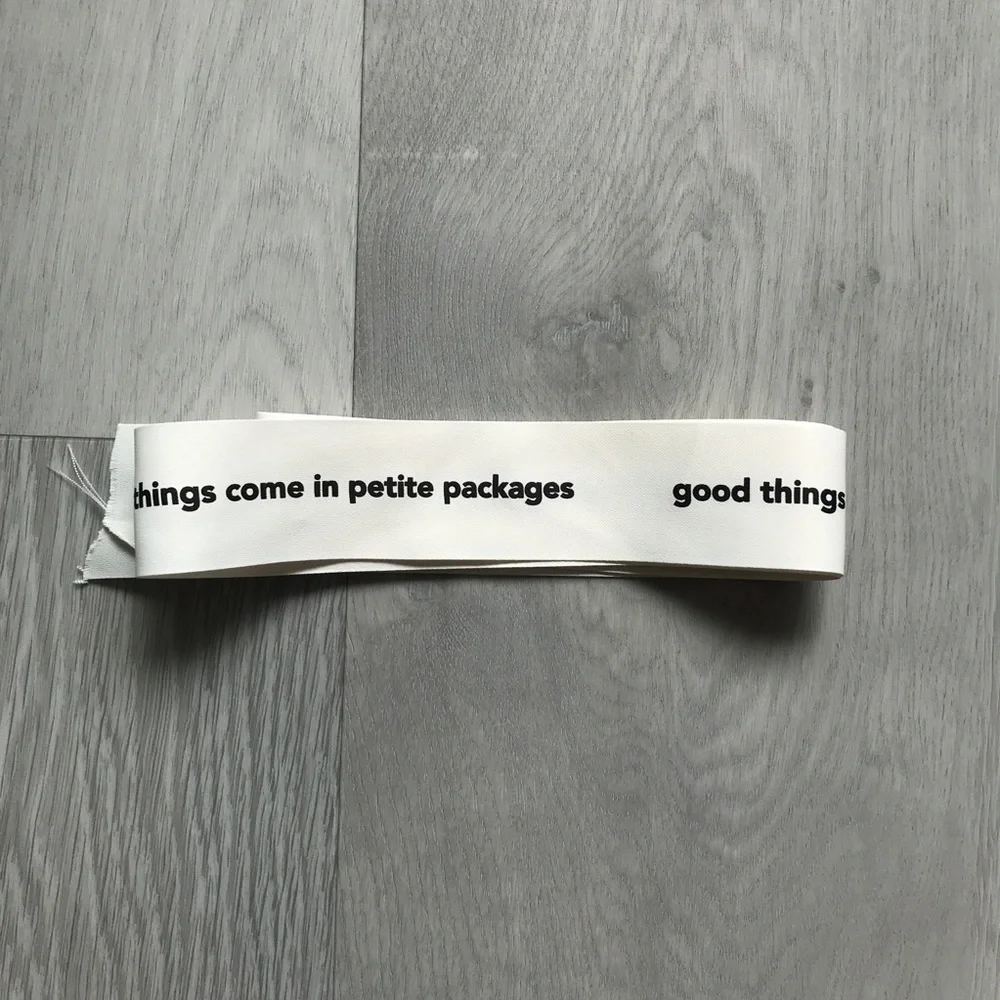 White Decorative Ribbon with Black Text - 'good things come in petite packages'